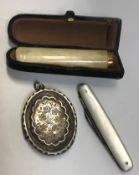 A yellow metal mounted bone cigarette holder, cased, together with a mother of pearl handled