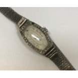 A ladies white gold mounted cocktail watch bezel set with small diamonds, the silvered dial with