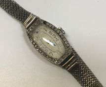 A ladies white gold mounted cocktail watch bezel set with small diamonds, the silvered dial with