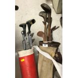 A leather mounted canvas golf bag containing eight vintage hickory shafted golf clubs bearing