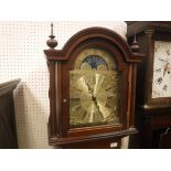 A modern mahogany cased long-case clock, the German musical movement with brass arched dial and