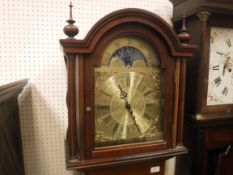 A modern mahogany cased long-case clock, the German musical movement with brass arched dial and