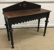 A late Victorian Gothic style side table with raised back on carved egg and dart and wrythen tapered