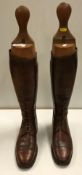 A pair of early 20th Century gentlemen's part laced brown leather hunting boots with wooden trees,