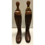 A pair of early 20th Century gentlemen's part laced brown leather hunting boots with wooden trees,