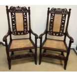 A pair of modern Chinese carved rosewood elbow chairs in the 17th Century European manner with caned