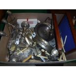 A box of various plated wares to include various cutlery, candlesticks, fruit bowl, place mats etc