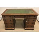 A Victorian mahogany double pedestal desk, the tooled and gilded leather insert top with moulded