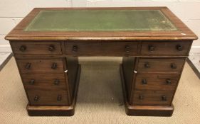 A Victorian mahogany double pedestal desk, the tooled and gilded leather insert top with moulded