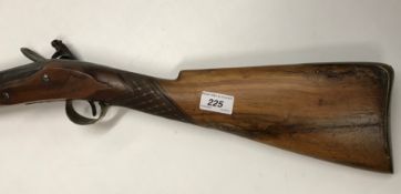 An 18th Century muzzle loading flintlock musket with walnut stock, the barrel bearing various