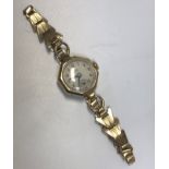 A 9 carat gold cased Avia ladies watch with 9 carat gold plated bracelet