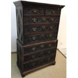 An early 19th Century chest on chest, later Victorian scrollwork foliate carved decoration, the
