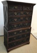 An early 19th Century chest on chest, later Victorian scrollwork foliate carved decoration, the