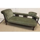 A late Victorian mahogany framed chaise longue with carved gallery back and buttoned upholstery on