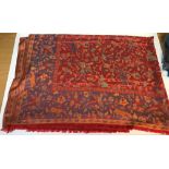 A modern shawl with floral and animal design on a red and blue ground, approx 204 cm long x 150 cm