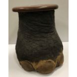 A late Victorian Elephant foot stool with circular mahogany top opening to reveal a coopered type