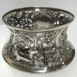An Edwardian Irish silver dish ring with pierced engraved and embossed decoration of birds amongst