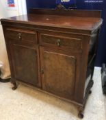 An early 20th Century burr walnut side cabinet with shallow raised back over two drawers and two