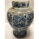 A 19th Century Dutch Delft baluster shaped vase decorated with panels of flowers in the Chinese