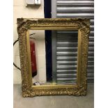 A gilt picture frame with acanthus leaf decoration to the corners - aperture 51 cm x 71.