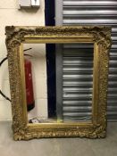 A gilt picture frame with acanthus leaf decoration to the corners - aperture 51 cm x 71.