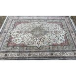 A Persian carpet, the central panel set with floral decorated medallion on a mushroom,