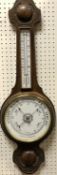 A circa 1900 carved oak cased aneroid barometer with mercury thermometer 79 cm high