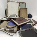 A large collection of silver plated photograph frames of various sizes