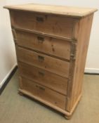 A 19th Century Continental pine chest of five long drawers on turned feet,