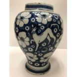 An 18th Century Dutch Delft baluster shaped vase with all-over prunus blossom and lion figure