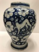 An 18th Century Dutch Delft baluster shaped vase with all-over prunus blossom and lion figure