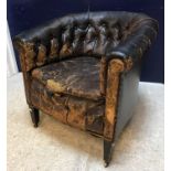 A 19th Century buttoned leather yoke back scroll arm chair on square tapered legs to casters 76 cm