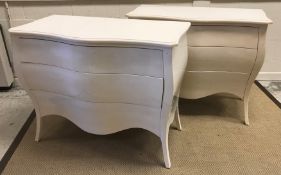 A pair of modern white lacquered commodes of bombe serpentine form,