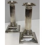 A pair of Edwardian silver table candlesticks of fluted column form,