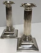 A pair of Edwardian silver table candlesticks of fluted column form,