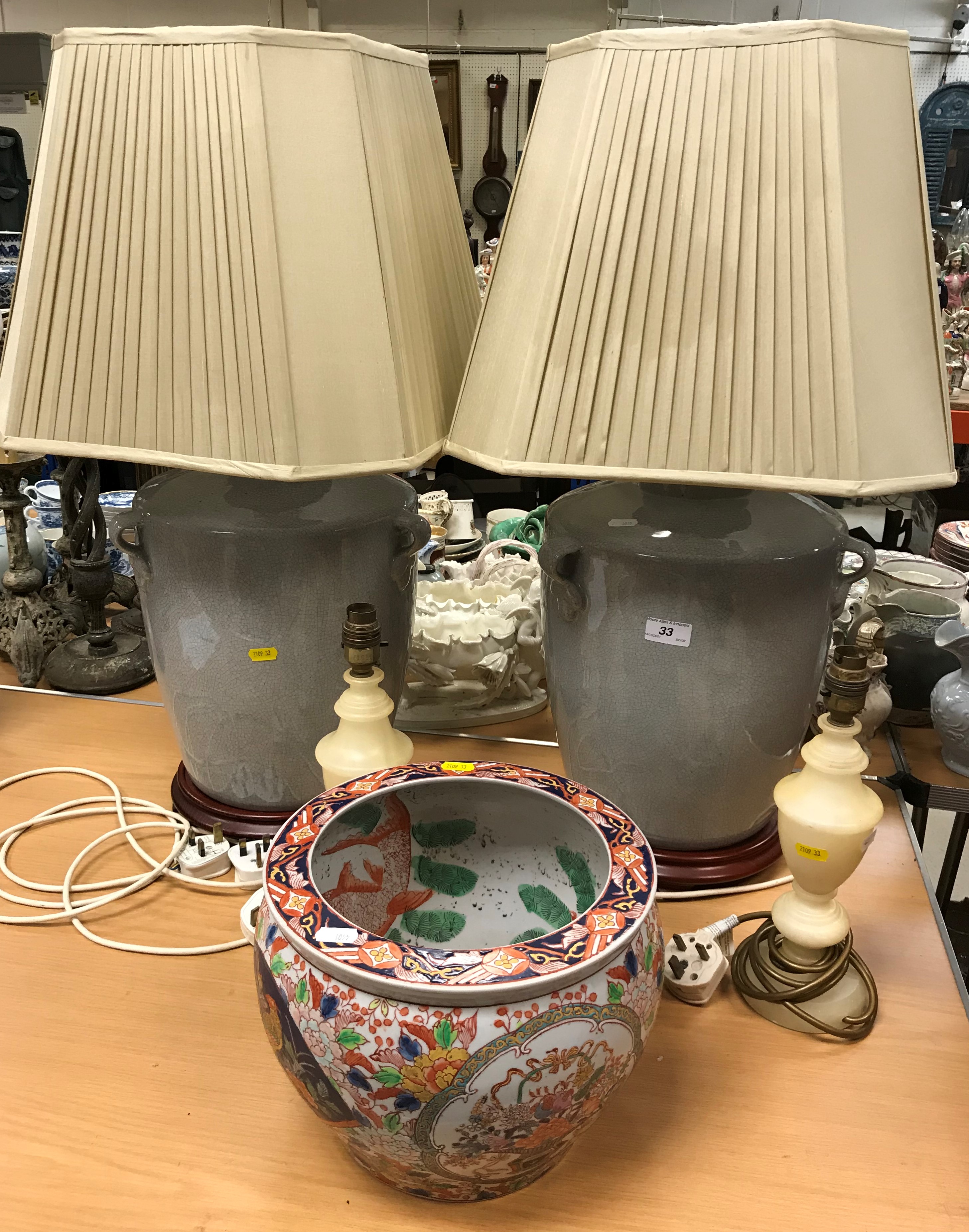 A pair of modern Chinese grey crackleware glazed vase style table lamps on stained beech turned