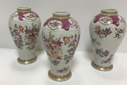 A set of three Samson of Paris urn-shaped vases decorated with armorials and floral sprays,