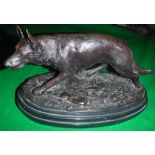 AFTER E. DROUOT "Prowling Wolf" a patinated bronze figure on an oval marble plinth base 25.