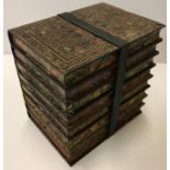 A Huntley & Palmer biscuit tin as a strap held bundle of eight library books 16 cm wide x 16 cm