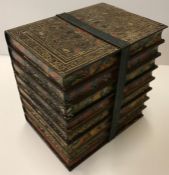 A Huntley & Palmer biscuit tin as a strap held bundle of eight library books 16 cm wide x 16 cm