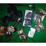 A collection of various photographic equipment including a Canon EOS750 camera,