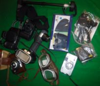 A collection of various photographic equipment including a Canon EOS750 camera,