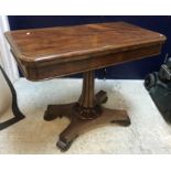A Victorian mahogany fold-over card table, the rectangular top with moulded edge,