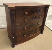 A 19th Century Victorian bow fronted chest of two short over three long graduated drawers flanked