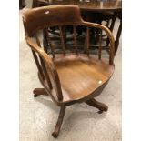 A circa 1900 oak spindle back swivel office chair on quadruped base and a modern teak eight section