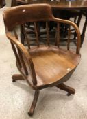 A circa 1900 oak spindle back swivel office chair on quadruped base and a modern teak eight section