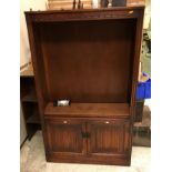 A modern oak bookcase cabinet in the 17th Century style,