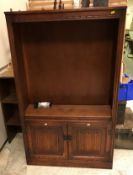 A modern oak bookcase cabinet in the 17th Century style,