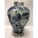 A 19th Century Dutch Delft baluster shaped vase with decoration of a Chinese figure with dog in a