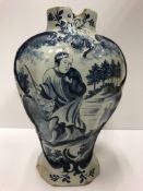 A 19th Century Dutch Delft baluster shaped vase with decoration of a Chinese figure with dog in a